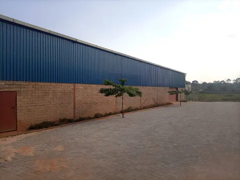 Aerial view of an East African industrial park with warehouse buildings, access roads, and surrounding landscape.