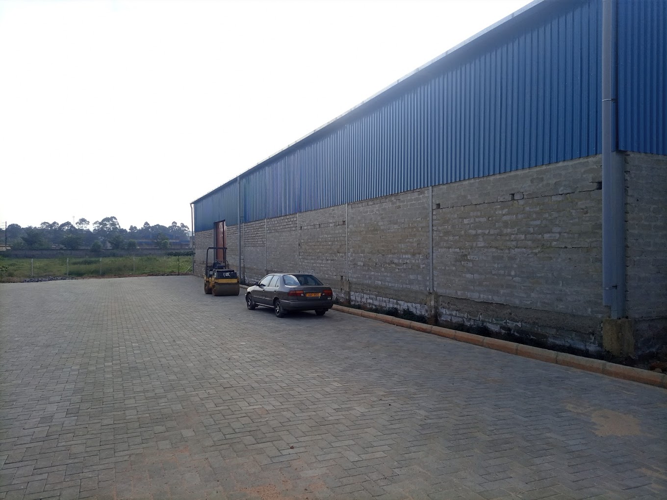 Exterior view of our warehouse space for rent in Kampala with plenty parking and green spaces